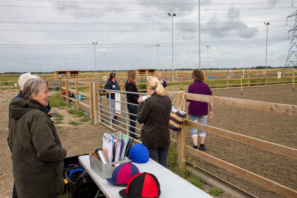 Image of volunteers and riding hats