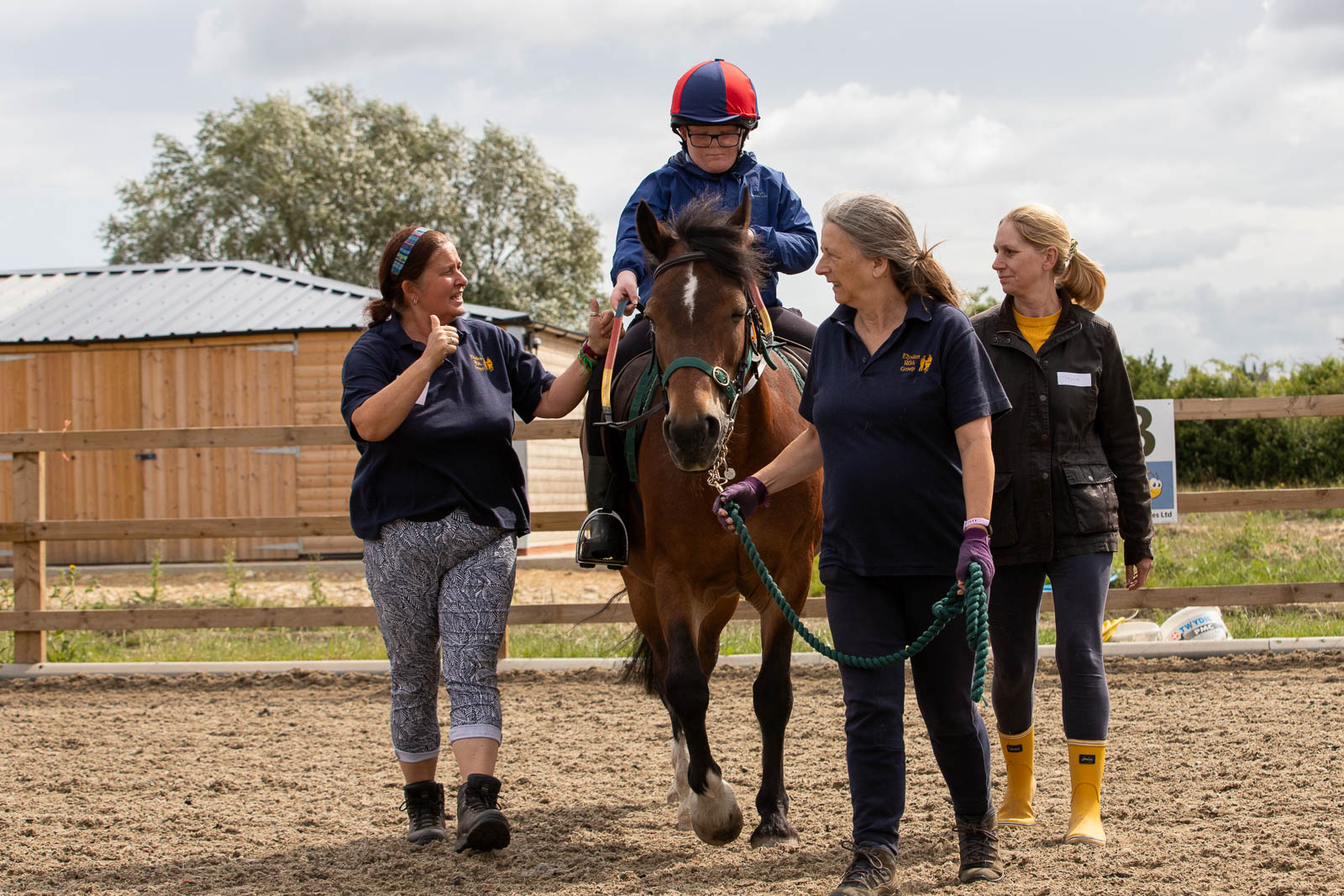 Rider on horse with support team